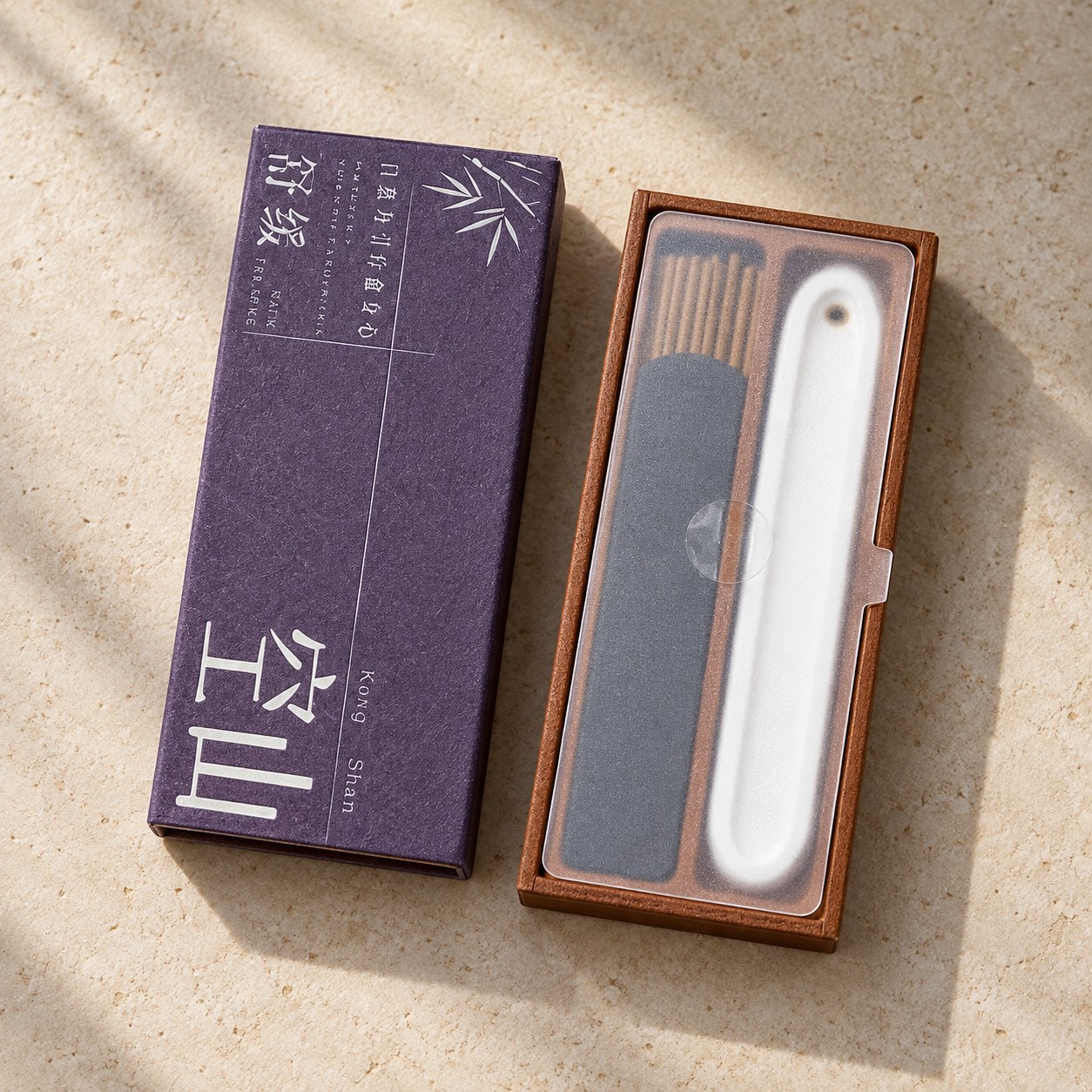 Purple Kong Shan incense box beside short incense sticks and a white ceramic holder in the inner tray